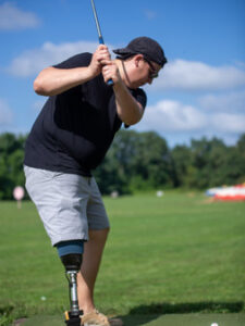 Man golfing with a prosthetic leg