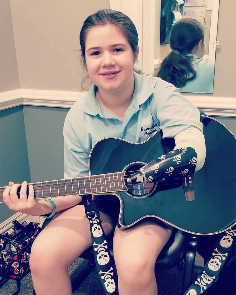 Girl with a guitar | Lawall Prosthetic & Orthotic Services